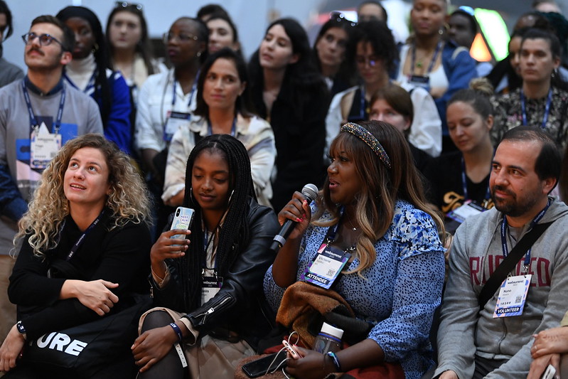 An attendee asks a question to Calema after they perform live on Q&A stage during day three of Web Summit 2022 at the Altice Arena in Lisbon, Portugal.